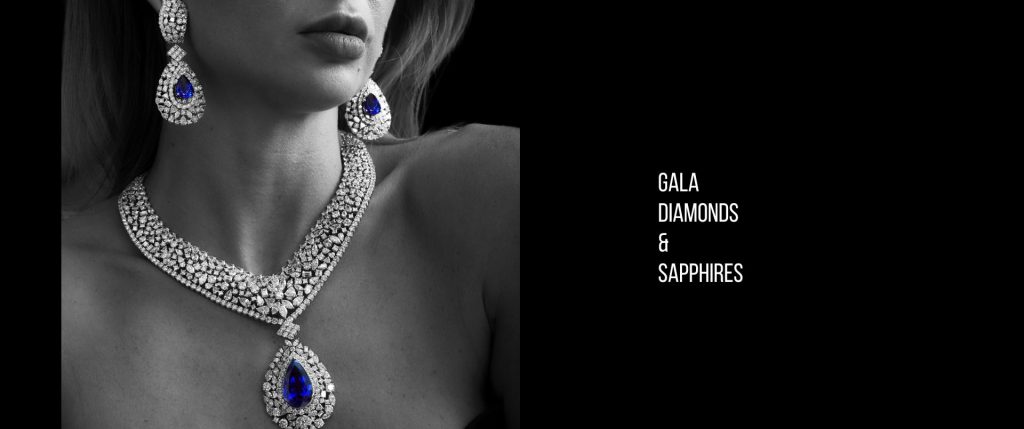 Close-up of a woman wearing an elegant gala necklace and earrings featuring diamonds and sapphires, highlighting the brilliant blue sapphires set in a luxurious design, all part of a one-of-a-kind vintage high-value gem collection from Dover Jewelry.